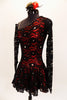 Red shimmery base one shoulder dress has  gathered skirt and black lace overlay with Swarovski accents throughout. The single sleeve and long gauntlet are both sheer black lace and accented with crystals. Comes with a matching red and black hair accessory. Left side