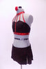 Black and red, glitter print, two piece costume, has five crystal covered straps that attach to a red choker style collar. The matching short/skirt has crystal edged side slit. Comes with red sparkled hair accessory. Side