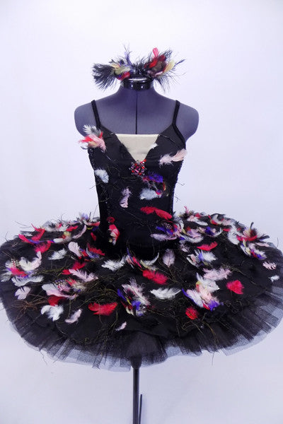  Black tutu with velvet bodice has hook & eye closure along back. The bodice is attached to bask of the crisp 10-layer pleated black tulle and ruffled panty.  The overlay and front bodice is adorned with hundreds of colorful feathers. Front