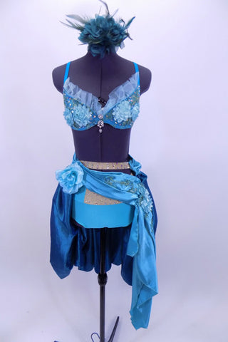 Aqua and teal costume has laced bra with silk roses & crystal broach. Separate panty & teal ruched taffeta skirt with beaded appliques. Many Swarovski crystals. Comes with teal hair accessory. Front