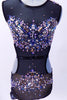 Black mesh leotard with open sides and back is lined with nude lycra in brief area. The costume is extensively covered with jewels, Swarovski crystals and metal studs along the bodice and hips.  Comes with metallic jewel hair accessory. Front  zoom