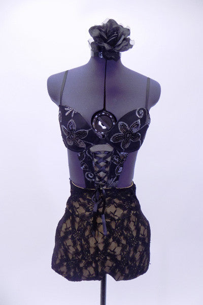 Black sequined lace bra  is attached to black, lined, high waisted short with marching V-shaped corset accent. Comes with matching hair accessory. Front