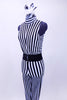 Black and white vertical stripped unitard has high collar and open back. It is lined in body with soft stretch knit.  Costume comes with wide black stretch belt accent and black & white feather accessory with birdcage veil. Side