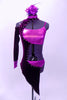 Mauve metallic half top and briefs are popped with a crystal edged purple velvet angular half tailcoat with cut-outs. The coat with sits on the right side, comes to a point at both front and back. It has a high collar that attaches at the back of the neck, an open shoulder and a single long sleeve with mauve cuff. Front
