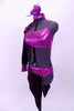Mauve metallic half top and briefs are popped with a crystal edged purple velvet angular half tailcoat with cut-outs. The coat with sits on the right side, comes to a point at both front and back. It has a high collar that attaches at the back of the neck, an open shoulder and a single long sleeve with mauve cuff. Left side