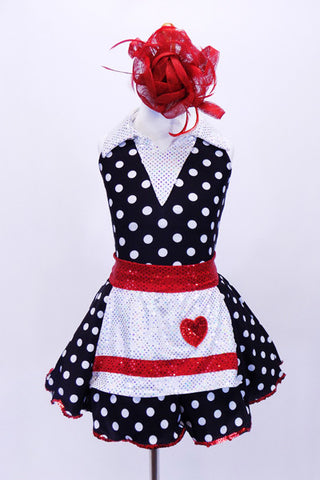 Halter style, black & white polk-a-dot leotard with white sparkle collar, has matching skirt with petticoat. Comes with a white sequined apron with red heart and large red hair accessory. Front
