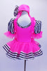 Pink costume has fluffy skirt over black and white polk-a-dot bodice,striped pouf sleeves & ribbon edging. The bodice and matching pill-hat have large crystal broach accents. Back