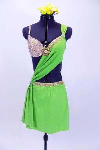 Apple green sarong dress over nude bra (34B) covered in Swarovski crystals has gold lace edging & large golden broach. Comes with green orchid hair accessory. Front