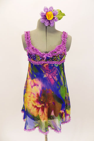 Silk chiffon baby-doll dress with built in bra (32A) has peony floral designs of royal blue, yellow, purple and green, scattered with crystals. Lavender lace edges the bodice area and straps. Gold, red crystals accent the entire bust area. Comes with purple shorts and matching floral hair accessory. Front