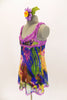 Silk chiffon baby-doll dress with built in bra (32A) has peony floral designs of royal blue, yellow, purple and green, scattered with crystals. Lavender lace edges the bodice area and straps. Gold, red crystals accent the entire bust area. Comes with purple shorts and matching floral hair accessory. Left side
