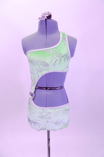 One shoulder mint velvet leotard has silver floral pattern with scattered crystals and large crystal ring accent at right hip. Has crystal hair accessory. Front