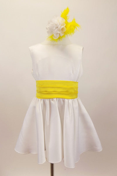 Sweet but simple white V-back dress has yellow pleated sash belt that ties at back Comes with yellow and white matching hair accessory. Front