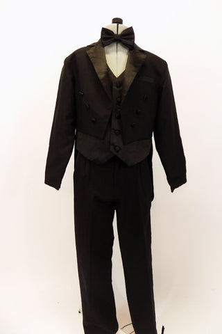 Three piece black evening tailcoat suit has  high waisted satin lapelled coat,over a black satin vest & pleated pants with satin stripe. Comes with bow tie. Front