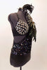 Black bra is covered with large jewel accents & sits beneath one shoulder, black sequined leotard dress with large feather accent on shoulder. Has feather hair accessory. Right side