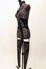Black mesh leotard has silver patterned inlays at bust, torso & sides lined with silver crystals. Has  pull on garter belt with attached stirrups & hair piece. Left side