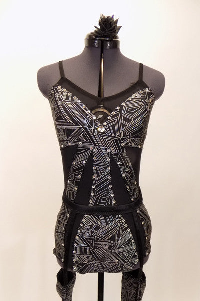 Black mesh leotard has silver patterned inlays at bust, torso & sides lined with silver crystals. Has  pull on garter belt with attached stirrups & hair piece. Front zoomed