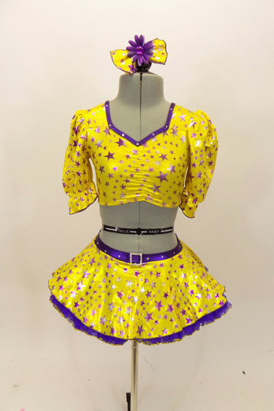 Bright yellow base with purple star print half top has large pouf sleeves with crystaled purple piping. Matching skirt has purple petticoat & bow hair accessory. Front