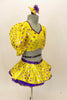 Bright yellow base with purple star print half top has large pouf sleeves with crystaled purple piping. Matching skirt has purple petticoat & bow hair accessory. Right side