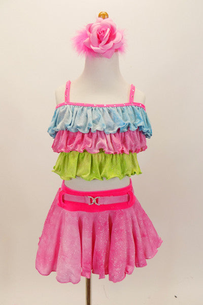 Pastel costume has tri-colored top in layered ruffles of glittery blue pink and green. The skirt is glittery pink with bright pink waistband and decorative pink crystal buckled belt. Comes with pastel pink floral hair accessory. Front