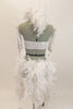 White sequined halter bra top is attached to white shorts by two straps that originate below the bust  by crystal ring accessory and attaches at the side of hips. There is an attached hip to hip bustle comprised of white and silver boa feathers. Comes with matching feather hair accessory and shiny white gauntlets. Back