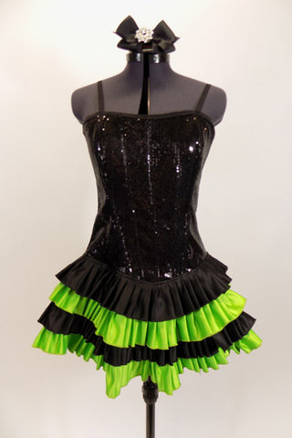 Black sequined & boned corset dress has grommet & lace  back. Has attached skirt with layers of ruffled green & black satin. Has separate panty & hair accessory. Front