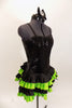 Black sequined & boned corset dress has grommet & lace  back. Has attached skirt with layers of ruffled green & black satin. Has separate panty & hair accessory. Right side