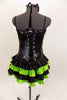 Black sequined & boned corset dress has grommet & lace  back. Has attached skirt with layers of ruffled green & black satin. Has separate panty & hair accessory. Back