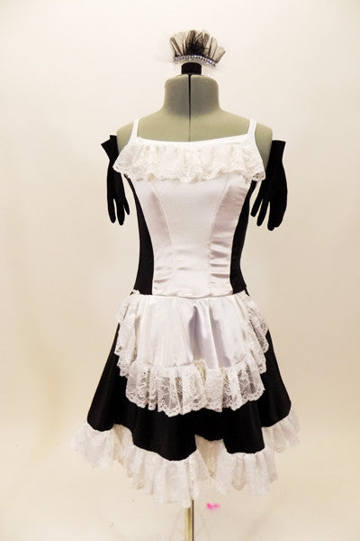 Black sateen French maid dress has princess seams with white center on bodice and attached white apron. The edge of the skirt, apron and bust has wide French lace trim. Comes with ruffled hair accessory & black gloves. Front