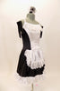 Black sateen French maid dress has princess seams with white center on bodice and attached white apron. The edge of the skirt, apron and bust has wide French lace trim. Comes with ruffled hair accessory & black gloves. Right side