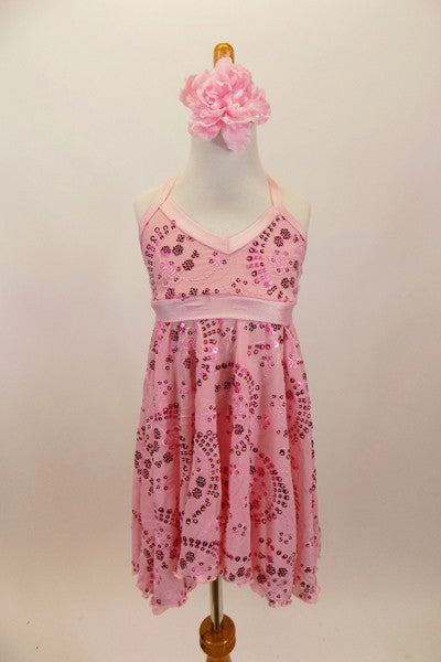 Pale pink flowy lyrical chiffon dress has a sequined floral pattern overlay and empire bust-line with pale pink band. There are separate pale pink lined briefs and a pale pink rose hair accessory. Front