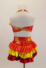 Iridescent yellow, red & orange costume has halter style top with yellow satin ruffle & shorts with layered bustle of red, yellow & orange satin ruffles. Comes with sequined hair accessory. Back