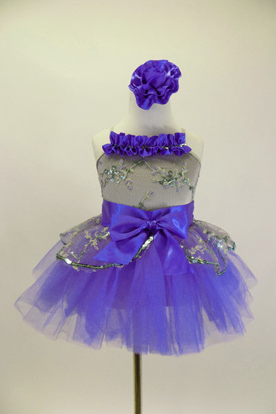Silver camisole leotard dress has silver lace overlay. Lace peplum sit on the periwinkle blue tutu skirt. Has satin waist with bow & ruffle along bust & hair accessory. Front 