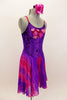 Purple crushed velvet leotard dress has long chiffon attached skirt with purple & fuchsia waves. Bodice has large sequined floral applique. Has rose hair piece. Right side