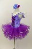 Blue and purple floral leotard has chiffon ruffle sleeves, silver trim & large purple applique on bodice. Has purple pull-on tutu & matching floral hair accessory. Left side