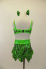 Lime green caveman print leotard dress has open sides, back & jagged skirt, Has pink glitter accents & crystals. Comes with wrist and leg scrunchies & hair bows. Back