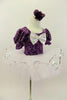 Purple velvet leotard has pouf sleeves & silver pattern. Neck-line is square cut with silver edging & large silver front bow. Comes with white pull-on tutu & floral hair accessory. Right side