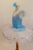Pale Blue velvet leotard has glittery wave pattern and peplum that rests overtop of white tulle, romantic tutu skirt. Comes with floral hair accessory. Left side