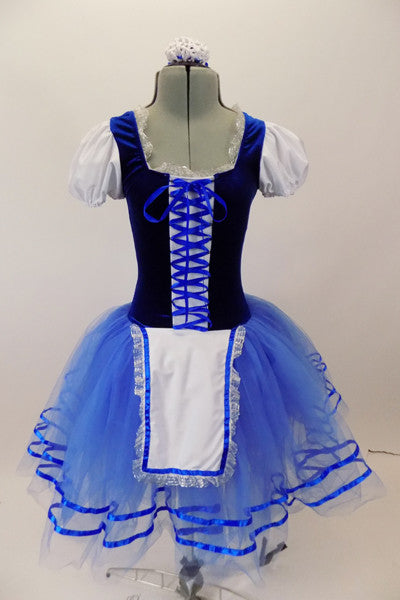 Peasant style  ballet dress has blue velvet bodice ,corset tie front & pouf sleeves. Skirt is layers of blue tulle with ribbon accent and a white apron. Comes with hair accessory. Front