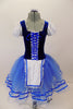 Peasant style  ballet dress has blue velvet bodice ,corset tie front & pouf sleeves. Skirt is layers of blue tulle with ribbon accent and a white apron. Comes with hair accessory. Front