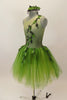Forest themed green romantic tutu dress has single shoulder with ribbon branches & 3-D leaves.Tutu is layers of soft green fading tulle. Has leaf hair accessory. Left side