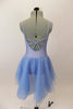 Pale blue leotard dress with floral accent has low back with looping cross strap design at lower back. The attached skirt is sheer layers of pale blue. Comes with hair accessory. Back