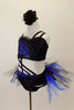 Blue and black costume is a two-piece joined at the front by cross straps. The top is black & blue animal print. Black briefs have black & blue tulle bustle. Has black floral hair accessory. Left side