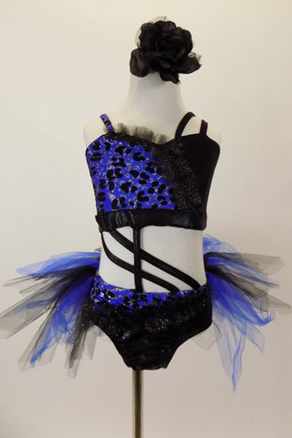Blue and black costume is a two-piece joined at the front by cross straps. The top is black & blue animal print. Black briefs have black & blue tulle bustle. Has black floral hair accessory. Front