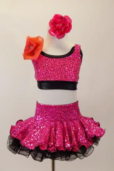 Fuchsia sequins over black organza ruffled skirt & matching half-top/ There is a large flower at the front of right shoulder. Has matching hair accessory. Front