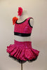 Fuchsia sequins over black organza ruffled skirt & matching half-top/ There is a large flower at the front of right shoulder. Has matching hair accessory. Left side