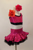 Fuchsia sequins over black organza ruffled skirt & matching half-top/ There is a large flower at the front of right shoulder. Has matching hair accessory. Right side
