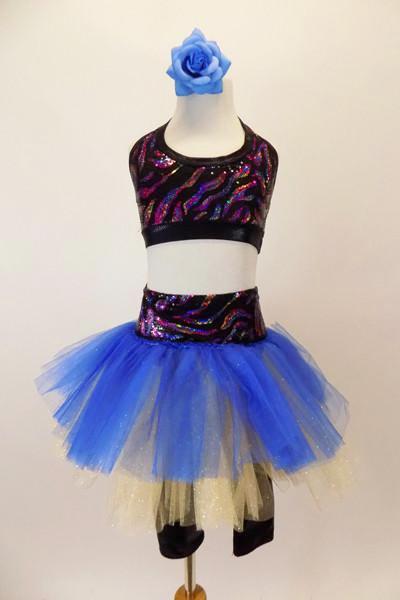 Black capri legging is attached to a gold & blue tutu with colorful sparkle waistband. The halter half top matches the waistband. Has blue floral hair accessory. Front