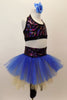 Black capri legging is attached to a gold & blue tutu with colorful sparkle waistband. The halter half top matches the waistband. Has blue floral hair accessory Right side