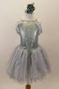 Silver romantic tutu dress had lace drop shoulder sleeves & silver braided accents. Skirt has layers of soft grey crystal tulle & silver sparkle sheer. Comes with matching floral hair accessory. Front