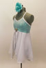 Aqua sequined leotard dress has cross back straps. Attached open-front white chiffon skirt has crystal rose brooch accent. Comes with aqua floral hair piece. Left side